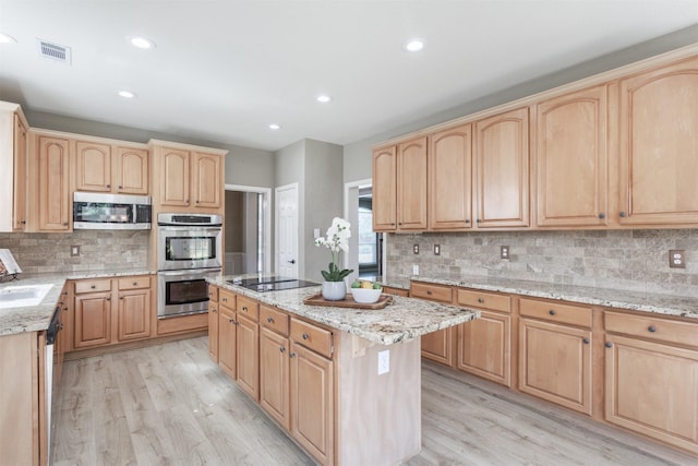 4109 Barnsley Dr, Plano, TX 75093 - kitchen featuring light brown cabinets, stainless steel appliances, a kitchen island, light wood-style floors, and recessed lighting