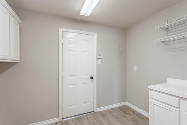 4109 Barnsley Dr, Plano, TX 75093 - laundry area with light wood-type flooring and baseboards