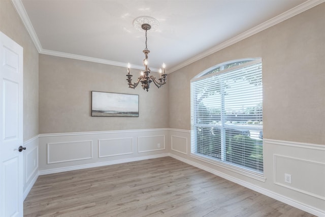 4109 Barnsley Dr, Plano, TX 75093 - spare room with a chandelier, light wood finished floors, crown molding, and a wainscoted wall