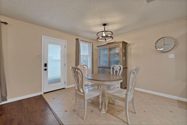 1819 Wildrose Dr, Rockwall, TX 75032 - dining room with a textured ceiling, baseboards, and a chandelier