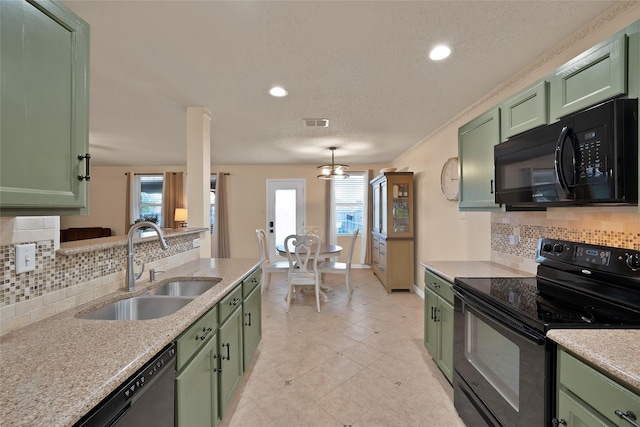 1819 Wildrose Dr, Rockwall, TX 75032 - kitchen with green cabinetry, black appliances, a sink, decorative backsplash, and a textured ceiling