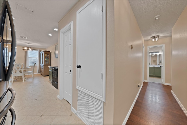 1819 Wildrose Dr, Rockwall, TX 75032 - hall with baseboards, a textured ceiling, and recessed lighting