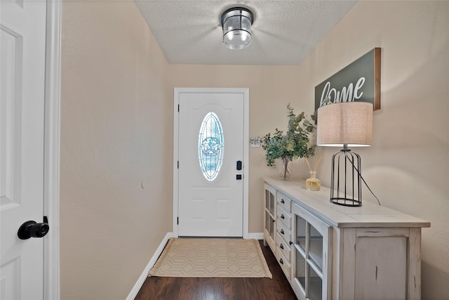 1819 Wildrose Dr, Rockwall, TX 75032 - foyer with baseboards, a textured ceiling, and dark wood-style floors