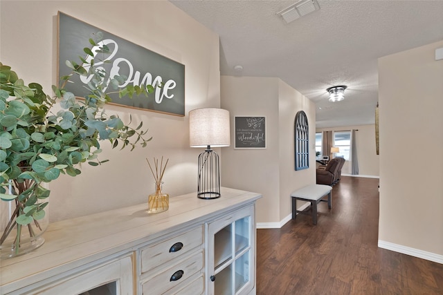 1819 Wildrose Dr, Rockwall, TX 75032 - hallway featuring dark wood finished floors, a textured ceiling, and baseboards