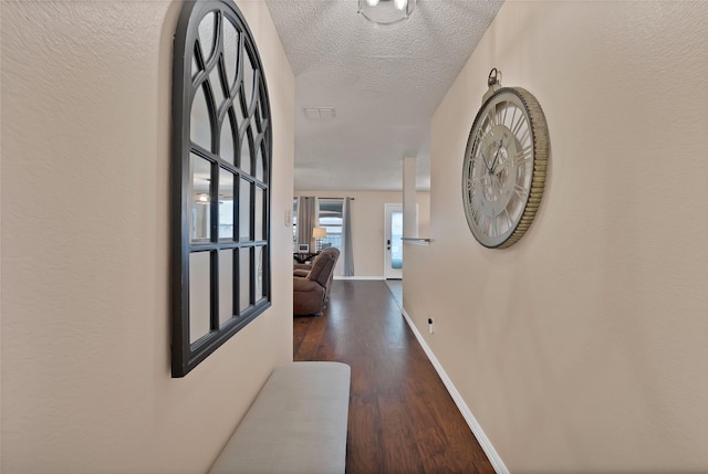 1819 Wildrose Dr, Rockwall, TX 75032 - hall with wood finished floors, baseboards, and a textured ceiling