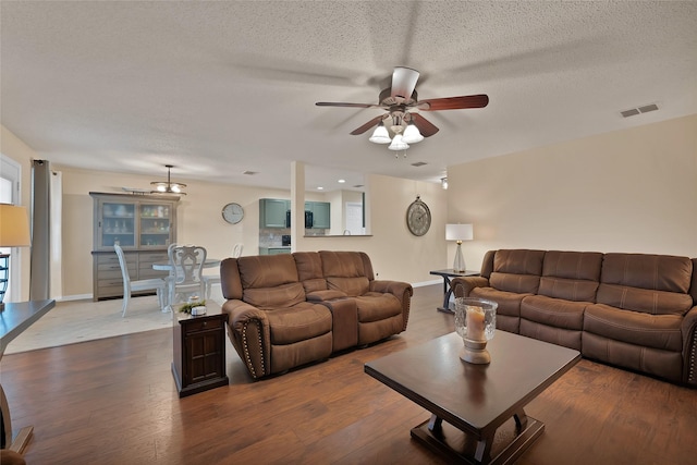 1819 Wildrose Dr, Rockwall, TX 75032 - living room featuring ceiling fan, wood finished floors, a textured ceiling, and baseboards