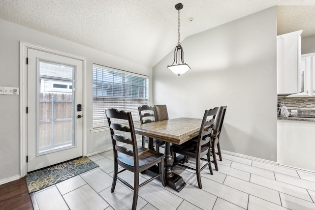 1629 Big Bend Dr, Lewisville, TX 75077 - dining area with vaulted ceiling, a textured ceiling, and wood tiled floors