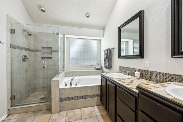 1629 Big Bend Dr, Lewisville, TX 75077 - full bathroom with double vanity, a bath, a shower stall, decorative backsplash, and tile patterned floors