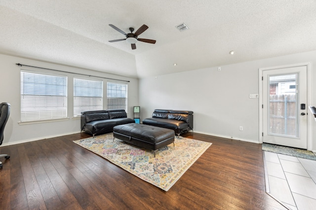 1629 Big Bend Dr, Lewisville, TX 75077 - living area featuring a ceiling fan, healthy amount of natural light, wood finished floors, baseboards, and a textured ceiling