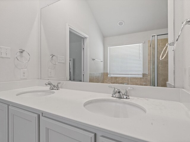 4204 Cordata Dr, Melissa, TX 75454 - bathroom featuring double vanity, tiled shower, and lofted ceiling