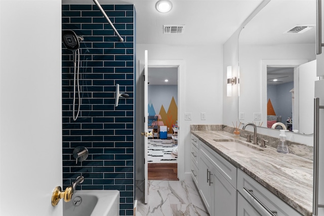 2909 N Britain Rd, Irving, TX 75062 - full bathroom with ensuite bathroom, marble look tiles, vanity, bathing tub / shower combination, and recessed lighting
