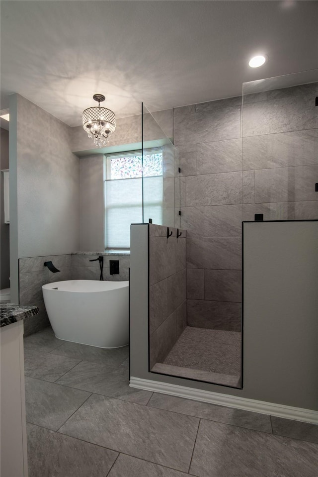 103 Saddle Club Rd, Weatherford, TX 76088 - bathroom with a walk in shower, a freestanding tub, a chandelier, and vanity