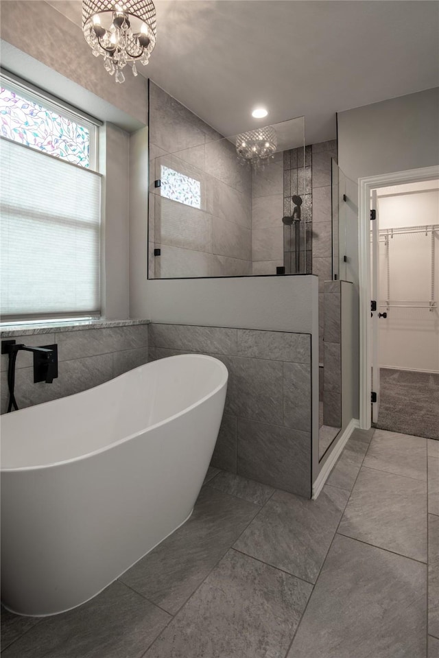 103 Saddle Club Rd, Weatherford, TX 76088 - full bath featuring a chandelier, a walk in shower, a soaking tub, and a walk in closet