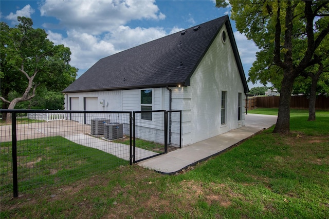 103 Saddle Club Rd, Weatherford, TX 76088 - back of property featuring a garage, a shingled roof, central AC, and a gate