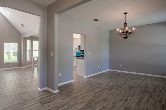 103 Saddle Club Rd, Weatherford, TX 76088 - spare room with a chandelier, wood finished floors, baseboards, and lofted ceiling