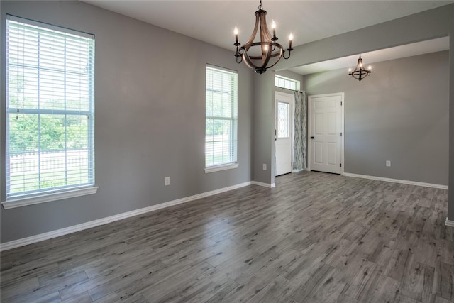 103 Saddle Club Rd, Weatherford, TX 76088 - empty room with a chandelier, baseboards, and wood finished floors