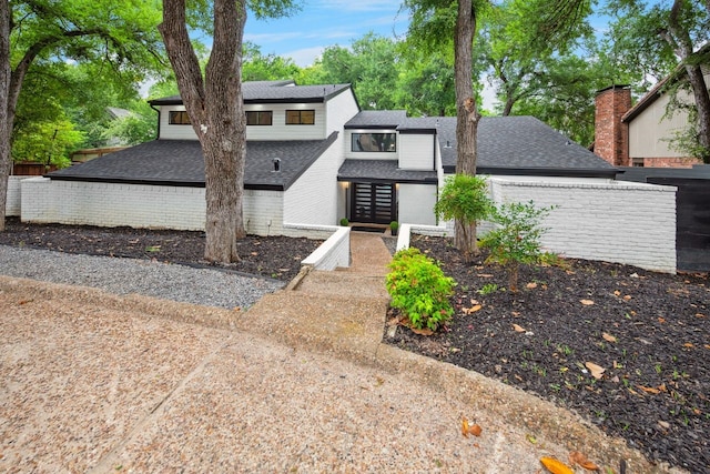 10823 Stone Canyon Rd, Dallas, TX 75230 - view of front facade featuring a shingled roof