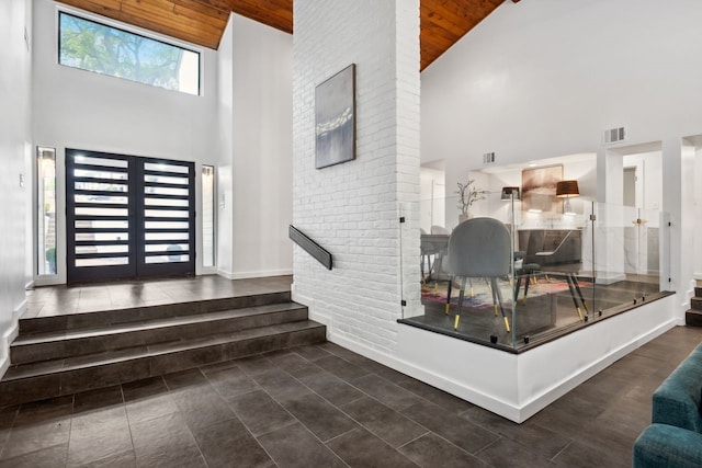 10823 Stone Canyon Rd, Dallas, TX 75230 - tiled entrance foyer with high vaulted ceiling, wooden ceiling, and baseboards