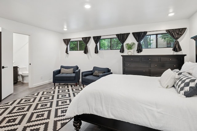 10823 Stone Canyon Rd, Dallas, TX 75230 - bedroom featuring recessed lighting, connected bathroom, baseboards, and wood finished floors