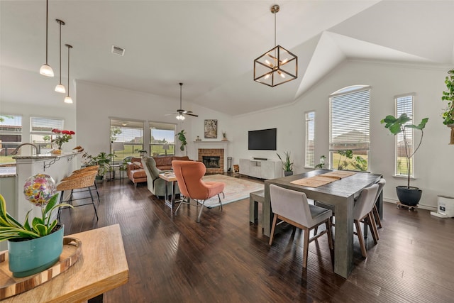 4756 Old Lorena Rd, Lorena, TX 76655 - dining space featuring ceiling fan, a brick fireplace, vaulted ceiling, dark wood finished floors, and a chandelier