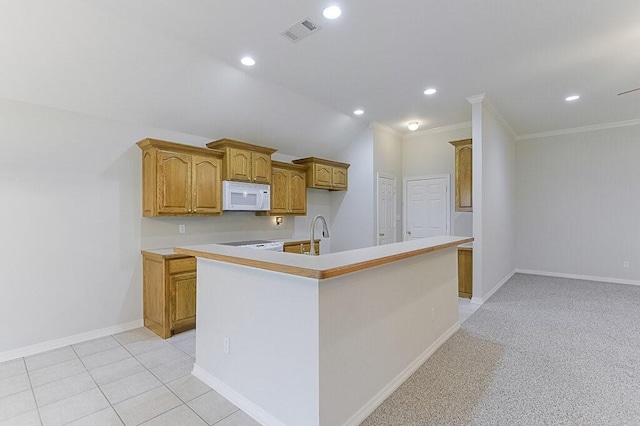 131 Crestridge Dr, Cedar Hill, TX 75104 - kitchen featuring white microwave, an island with sink, brown cabinetry, recessed lighting, and light countertops