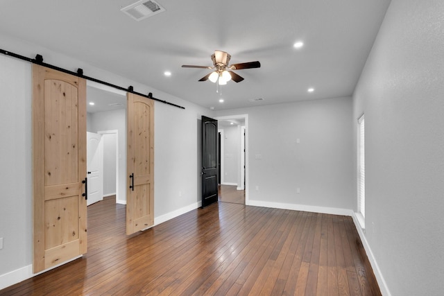 815 N Seven Points Dr, Kemp, TX 75143 - unfurnished bedroom with a barn door, dark wood-style flooring, baseboards, and recessed lighting
