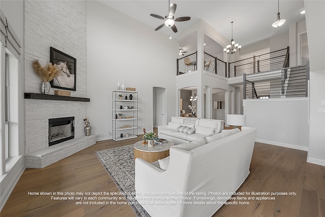 5226 Rowlan Row, Midlothian, TX 76065 - living room featuring arched walkways, a high ceiling, baseboards, ceiling fan, and a fireplace