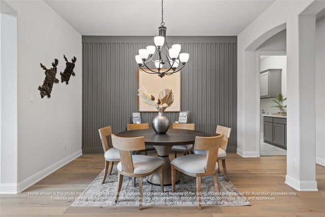 5226 Rowlan Row, Midlothian, TX 76065 - dining space with a chandelier, arched walkways, baseboards, and light wood finished floors