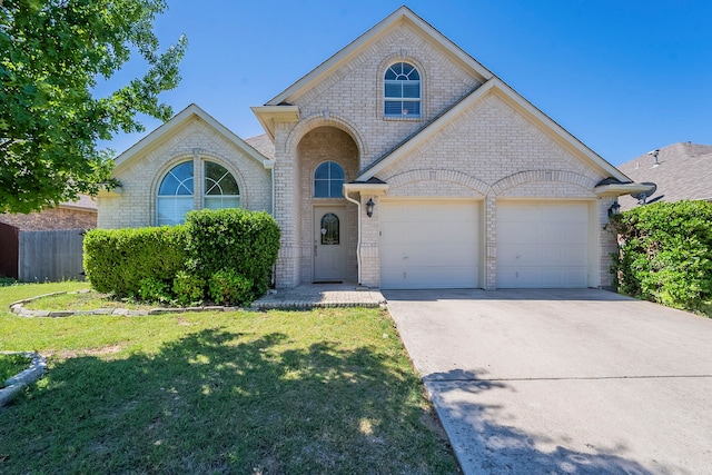 6937 Andress Dr, Fort Worth, TX 76132 - french country inspired facade with an attached garage, concrete driveway, and brick siding