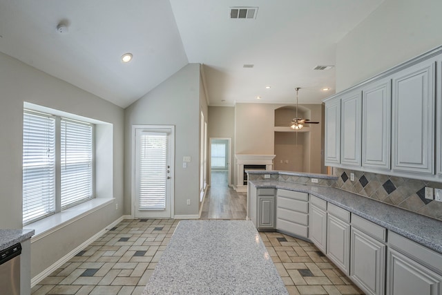 6937 Andress Dr, Fort Worth, TX 76132 - kitchen with a ceiling fan, baseboards, dishwasher, vaulted ceiling, and a peninsula