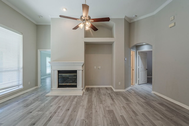 6937 Andress Dr, Fort Worth, TX 76132 - unfurnished living room with a ceiling fan, arched walkways, ornamental molding, light wood-style flooring, and baseboards