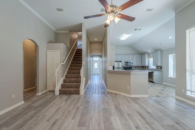 6937 Andress Dr, Fort Worth, TX 76132 - kitchen with appliances with stainless steel finishes, arched walkways, light wood-style flooring, light countertops, and ceiling fan