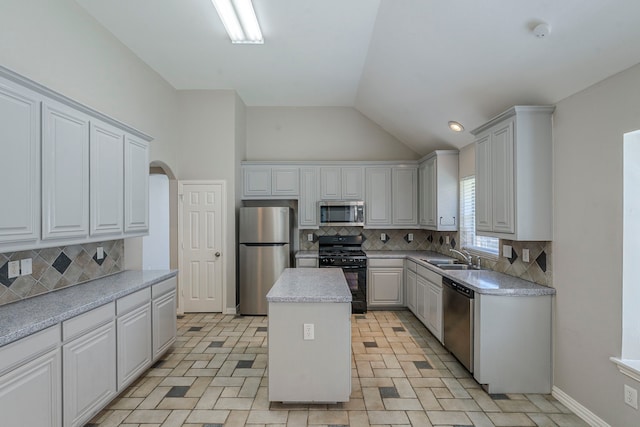 6937 Andress Dr, Fort Worth, TX 76132 - kitchen featuring appliances with stainless steel finishes, backsplash, lofted ceiling, a center island, and light countertops