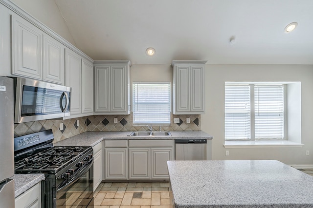 6937 Andress Dr, Fort Worth, TX 76132 - kitchen featuring appliances with stainless steel finishes, a sink, decorative backsplash, recessed lighting, and a center island