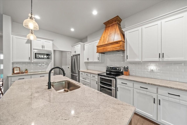 184 Lakeview Cir, Pilot Point, TX 76258 - kitchen featuring stainless steel appliances, a sink, custom range hood, white cabinets, and backsplash