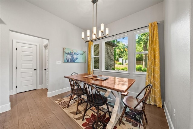 184 Lakeview Cir, Pilot Point, TX 76258 - dining area featuring baseboards, wood finished floors, and a chandelier