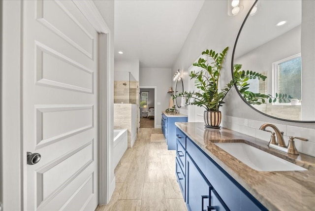 184 Lakeview Cir, Pilot Point, TX 76258 - bathroom featuring vanity, a tub to relax in, a shower, and recessed lighting