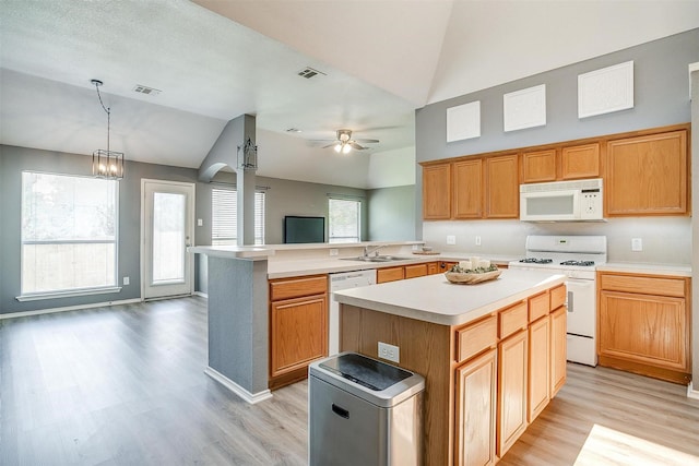 9805 Rockledge Rd, Fort Worth, TX 76108 - kitchen with white appliances, vaulted ceiling, a sink, light countertops, and light wood finished floors