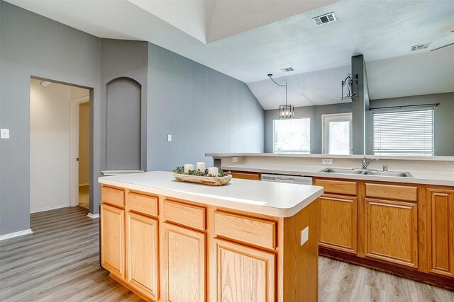 9805 Rockledge Rd, Fort Worth, TX 76108 - kitchen featuring a sink, light wood-style flooring, light countertops, a center island, and pendant lighting