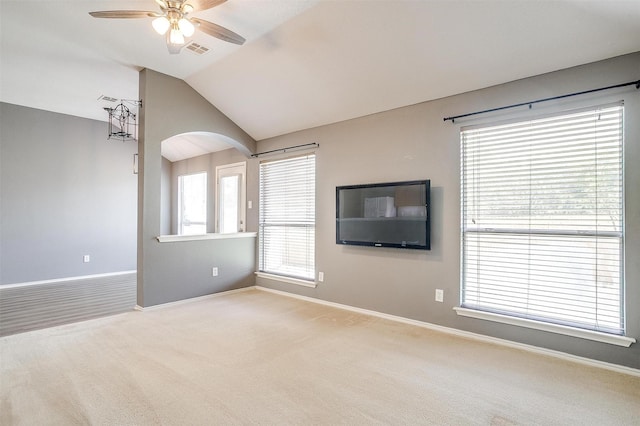 9805 Rockledge Rd, Fort Worth, TX 76108 - unfurnished living room featuring ceiling fan, baseboards, lofted ceiling, arched walkways, and carpet floors