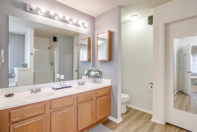 9805 Rockledge Rd, Fort Worth, TX 76108 - full bathroom featuring toilet, wood finished floors, double vanity, a shower, and baseboards