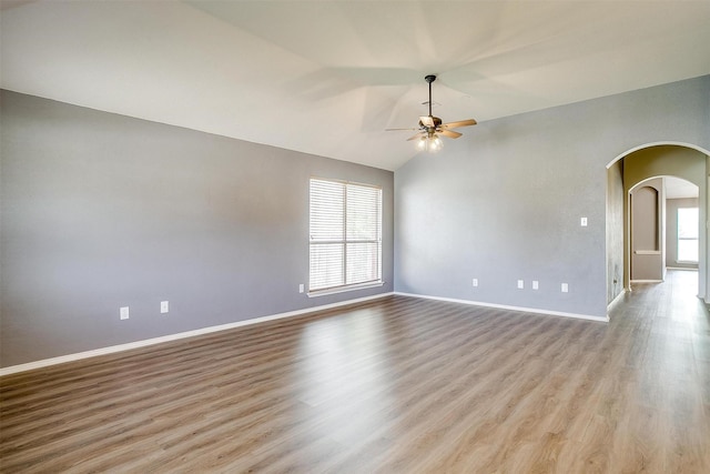 9805 Rockledge Rd, Fort Worth, TX 76108 - spare room with arched walkways, ceiling fan, baseboards, lofted ceiling, and wood finished floors