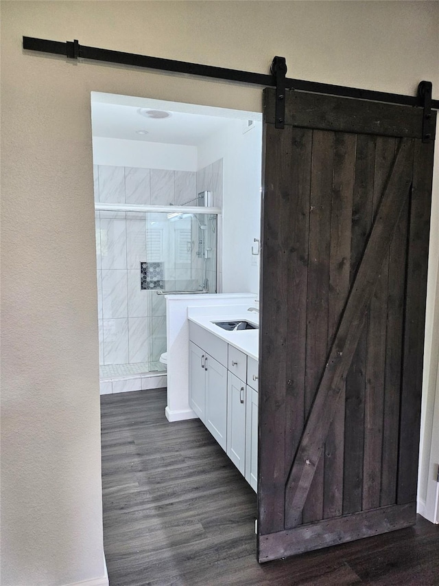 8601 Park Ln Unit 111, Dallas, TX 75231 - full bath with wood finished floors, a stall shower, vanity, toilet, and baseboards