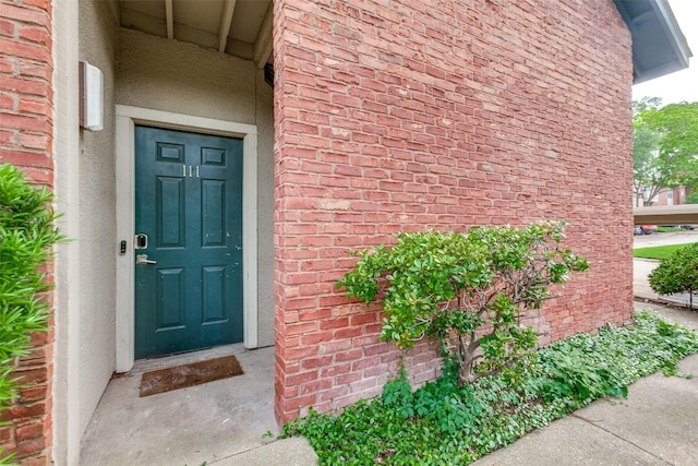 8601 Park Ln Unit 111, Dallas, TX 75231 - doorway to property with stucco siding and brick siding
