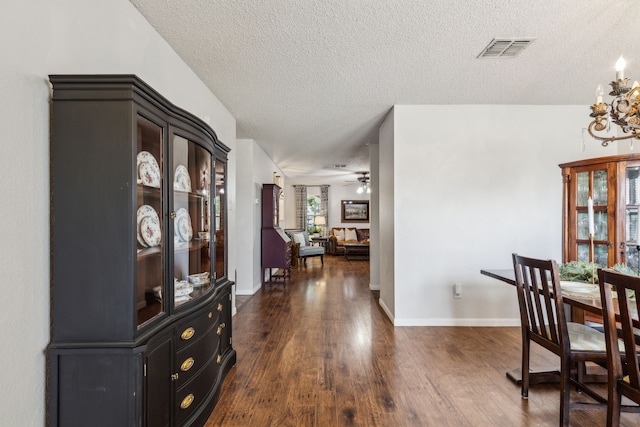 2300 Avalon Creek Way, Mckinney, TX 75071 - dining room featuring a textured ceiling, dark wood-style flooring, ceiling fan, baseboards, and a chandelier