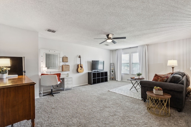 2300 Avalon Creek Way, Mckinney, TX 75071 - living room featuring carpet flooring, an office area, a ceiling fan, a textured ceiling, and baseboards