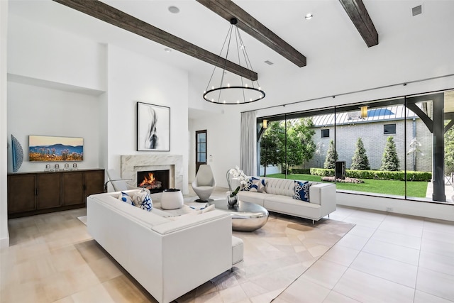 315 Oxford Pl, Coppell, TX 75019 - living area with a premium fireplace, beamed ceiling, high vaulted ceiling, light tile patterned floors, and a chandelier