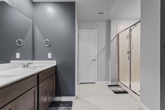 506 Cool Canyon Trl, Princeton, TX 75407 - full bathroom with baseboards, a stall shower, double vanity, and a textured wall