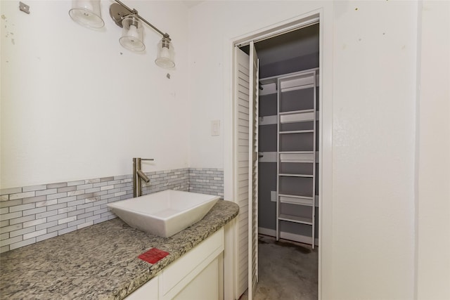 245 Straw Rd, Saginaw, TX 76179 - bathroom featuring a sink, backsplash, and a closet