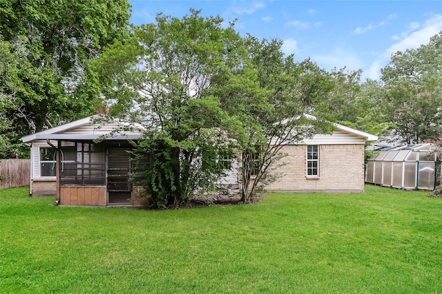 245 Straw Rd, Saginaw, TX 76179 - back of house with a greenhouse, brick siding, and an outbuilding